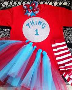 a red shirt and blue tutu skirt with the number one on it