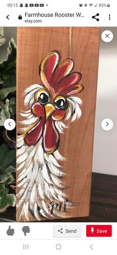 a painting of a rooster on a wooden block