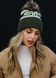 All of our Midwest people - this hat is for you! Our team designed this olive and beige pom hat with the true Midwesterner in mind. You'll keep grabbing this winter accessory time and time again this season.  Olive and ivory Midwest knit hat Natural faux fur pom accent Crown patch on the left side One size Designed in the U.S.A. Produced in China. 100% Acrylic Midwest Winter, Stocking Hats, Pom Hats, Beige Hat, Faux Fur Pom Pom, Pom Pom Hat, Pom Beanie, Fur Pom Pom, Cozy Fashion