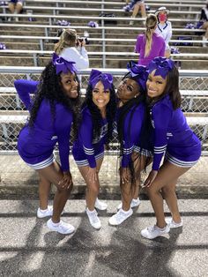 the cheerleaders are all dressed in purple