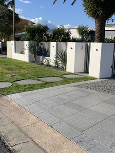 a white fence and some grass in front of it