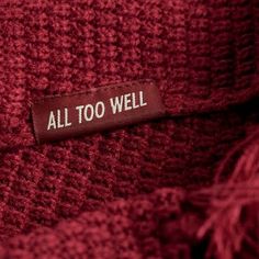 a label on a red sweater that says, all too well