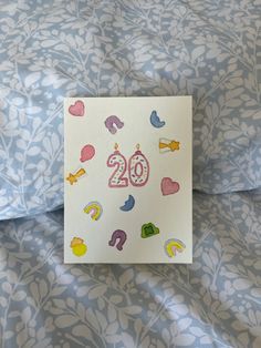 a birthday card with the number twenty two on it sitting on top of a bed