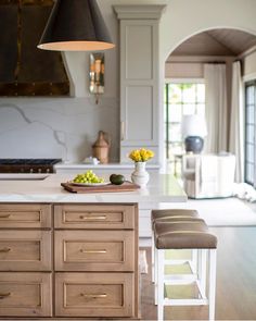 a kitchen with an island and stools in it