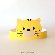 a paper tiger head on top of a yellow belt