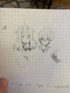 someone holding up a piece of paper with two anime characters drawn on it in front of them