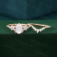 two gold rings with white diamonds on green velvet