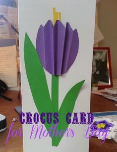 a mother's day card with purple flowers cut out of paper and the words, crocus card for mothers day