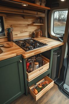 an open drawer in the side of a camper with wood cabinets and drawers on it