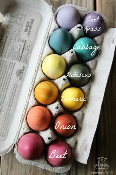 an egg carton filled with different colored eggs