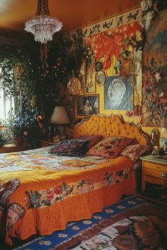 a bedroom with an orange bed and floral wallpaper on the walls, along with a chandelier hanging from the ceiling