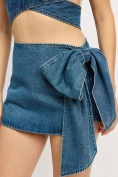 This stylish Denim Bow Mini Skirt is the perfect addition to any wardrobe. Made from high-quality denim, it features a charming bow detail that adds a touch of femininity. With its versatile design, this skirt can be dressed up or down, making it a must-have for any fashion-forward individual. SIZE & FIT :MODEL WEARS SIZE SMALLMODEL'S HEIGHT 5'9 Made In: IMPORTED Fabric Contents: 100% COTTON Chic Denim Skort For Summer, Chic Denim Blue Skort For Summer, Chic Medium Wash Skort For Summer, Summer Chic Medium Wash Skort, Chic Medium Wash Summer Skort, Chic Denim Skort For Spring, Chic High Waist Denim Blue Skort, Spring Denim Blue Denim Skort, Chic Spring Denim Blue Skort