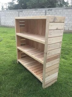 a wooden shelf sitting in the grass