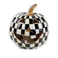 a black and white checkered pumpkin sitting on top of a table