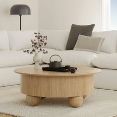 a living room with a white couch and coffee table