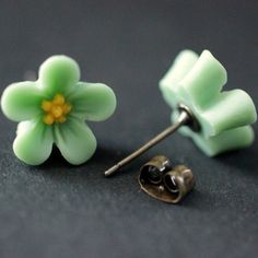 A pair of little 14mm resin forget-me-not flowers handmade in pastel green with bright yellow centers have been set upon bronze stud earrings (no nickel) in this pair of handmade earrings that also come with a matching set of bronze earring backs. Size: 14mm flowers If you would like to order a larger quantity than what's offered in this listing, please contact me for availability! These earrings are available in a variety of colors! http://etsy.me/1y0Bfr5 Stop by and visit http://stumblingonsai Green Flower Earrings, Forget Me Not Flower, Bronze Earrings, Flowers Handmade, Earrings Flower, Earrings Green, Green Flower, Flower Jewelry, Green Earrings