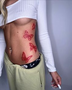 a woman with red butterflies on her stomach