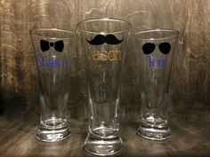 three glasses with mustaches and bow ties on them are sitting next to each other