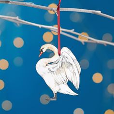 an ornament hanging from a wire with a bird on it's back