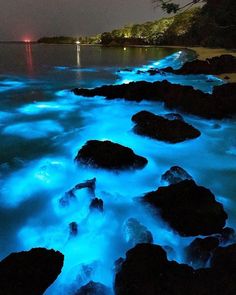 some rocks and water at night time