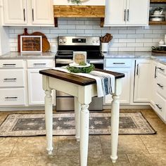 a kitchen with white cabinets and an island