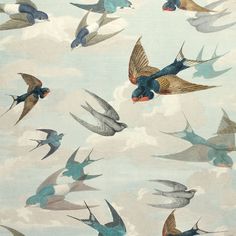 a flock of birds flying through the sky on a cloud filled day with blue and white clouds