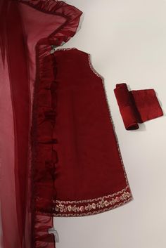 Canvassed on a jewel pomegranate tone of deep maroon in pure raw silk 58 Gms heavily embellished with embroidery details alongside hand/ada work, styled with matching trousers and pure frilly organza dupatta. Turns heads in this beautiful design. The length of the open shirt is 40 inches. Order Duration: 4 to 6 weeks Open Shirt, Deep Maroon, Organza Dupatta, Embroidery Details, Raw Silk, Pomegranate, Beautiful Design, Trousers, Silk