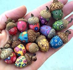 there are many different colored beads in the palm of a person's hand,