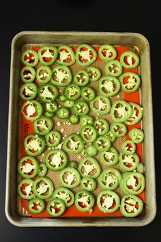 green peppers on a baking sheet ready to go into the oven with cheese and seasoning