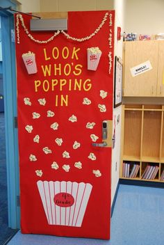 a red door with popcorn on it that says, look who's popping in