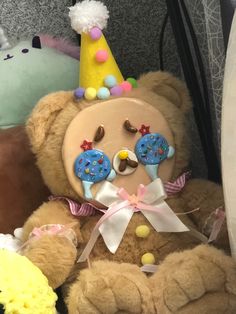 a brown teddy bear wearing a party hat