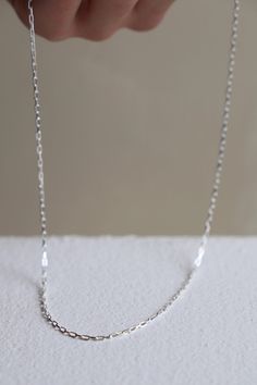 Crafted from delicate sterling silver, this Miniature Paperclip Chain is perfect for layering with your favorite necklaces. With its understated design, this chain adds a subtle touch of elegance to any outfit. Its versatility and lightweight feel make it a must-have piece for any jewelry collection. Stirling silver Made in the USA Cool Clothing, Stirling, Paper Clip, Silver Chain, Make It, Jewelry Collection, Layering, Miniatures, Necklaces