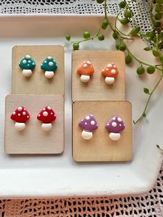 four small mushroom studs are sitting on a tray