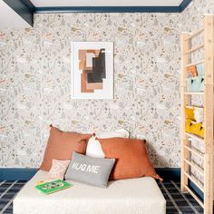 a bedroom with a bed, bookshelf and pictures on the wall