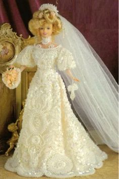 the barbie doll is wearing a wedding dress and veil