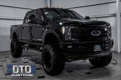 a large black truck parked in a garage