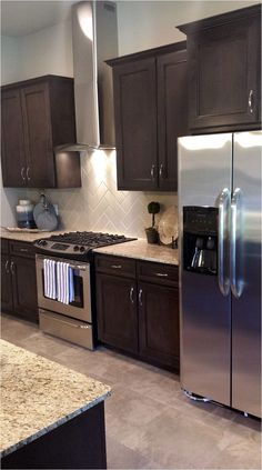 a kitchen with granite counter tops and stainless steel appliances in the middle of the room