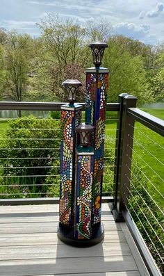 an artisticly designed lamp stands on a deck