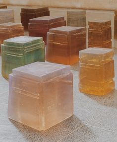 there are many different colored cubes sitting on the ground in front of each other