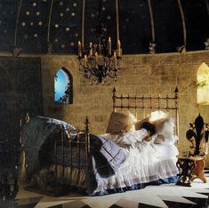 a bedroom with a bed and chandelier in it