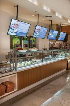 a buffet area with multiple televisions and food