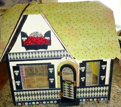 a doll house made out of cardboard sitting on top of a counter