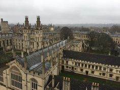 an aerial view of old buildings and spires on a cloudy day in the uk