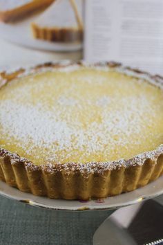 a pie on a plate with powdered sugar on top