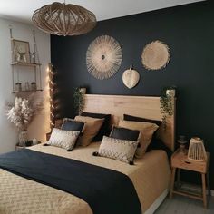 a bedroom decorated in black and gold with lights on the headboard, bedding and pillows