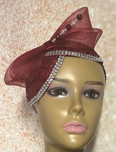 Burgundy and Wine Sinamay Fascinator Hat accented with burgundy sinamay and crinoline bows. Perfect for church, weddings, funerals and special occasions. Unique design accented rhinestones, bows and hat pin. Hat pin may vary. Hat measures approximately 9.5x5 inches. The hat affixes to the head by a hat elastic. Love what you see, but would like it in a different color, shape or size? Please contact us by sending a message. We offer custom hats in a variety of styles. PLEASE NOTE All items for Fr Elegant Hat With Satin Bow For Party, Elegant Party Hat With Satin Bow, Elegant Holiday Fascinator For Evening, Elegant Holiday Evening Fascinator, Elegant Fitted Fascinator With Ribbon, Elegant Holiday Party Fascinator, Elegant Bow Fascinator For Party, Elegant Party Fascinator With Bow, Elegant Party Fascinator With Satin Bow