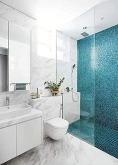 a bathroom with blue and white tiles on the walls