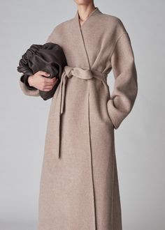 Full length coat in luxurious double faced wool cashmere. Tonal taupe contrast. Self Belt. Side seam pockets. 90% Wool, 10% Cashmere Taupe 6038BWCS-CORE Generous fit Total length xs/s = 52" M/L = 53" Model is 5'9" wears a size XS/S Beige Cashmere Winter Outerwear, Luxury Long Sweater Coat, Chic Long Cashmere Outerwear, Elegant Wool Coat With Pockets, Elegant Spring Cashmere Wool Coat, Chic Long Cashmere Coat, Luxury Wool Coat With Pockets For Fall, Beige Long Cashmere Wool Coat, Neutral Cashmere Long Sleeve Outerwear