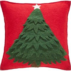 a red pillow with a green christmas tree on the front and white star on the back