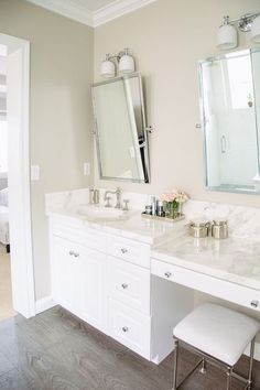 a white bathroom with two sinks and mirrors